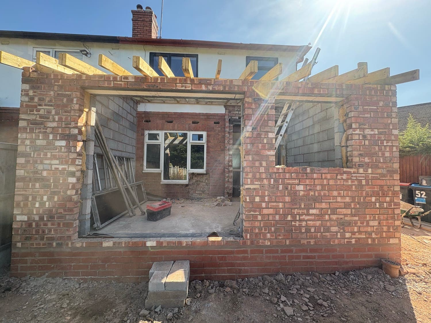 Extension part-built in brick and blockwork, with the roof timbers going on