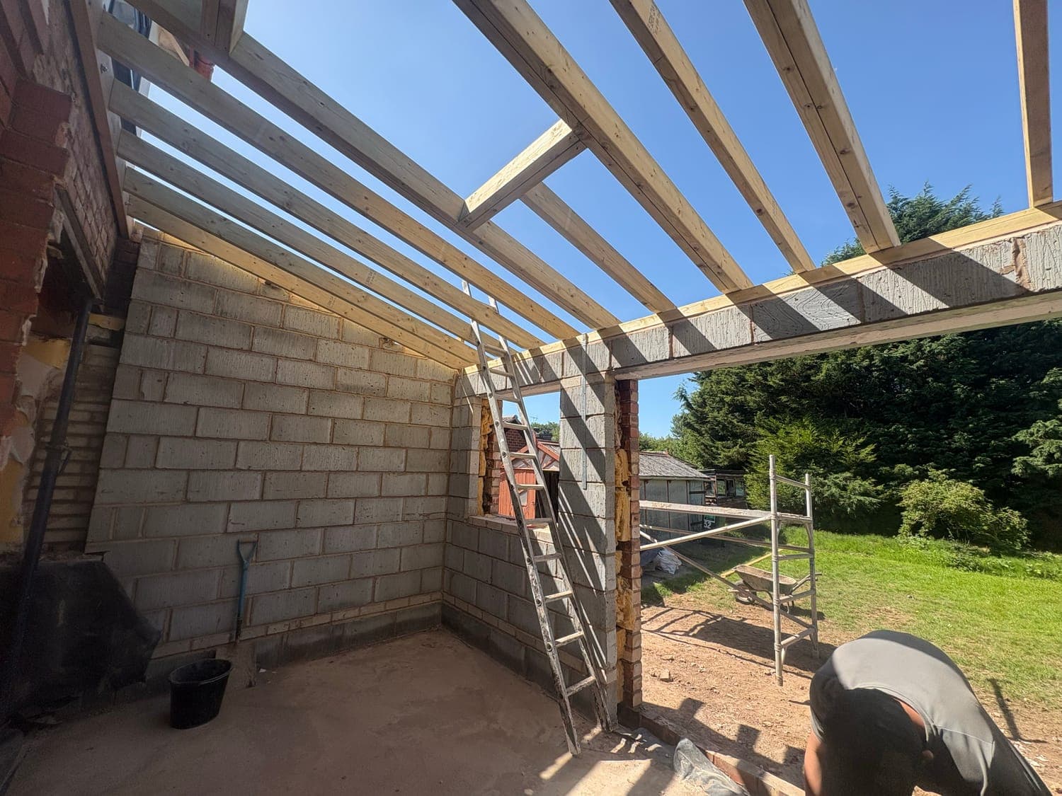 Extension shell in brick and blockwork with the roof timbers set out above
