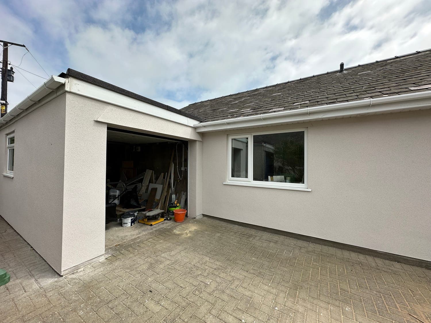 Rear elevation and garage of a bungalow finished in pale silicone render