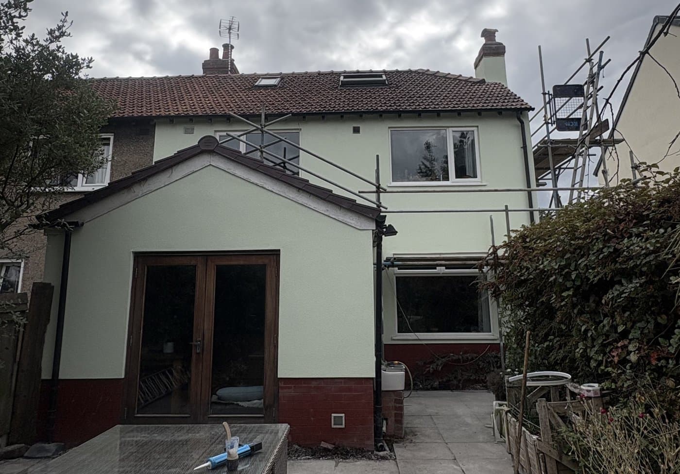 The same house and extension finished in a pale render